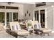 Inviting covered patio with lounge chairs, neutral colored couch, and decor to enjoy the outdoors at 6824 283Rd E St, Myakka City, FL 34251
