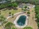 Aerial view of sprawling property with a pond, home, and lush landscaping at 6824 283Rd E St, Myakka City, FL 34251