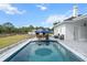 Outdoor pool with covered bar, lounge chairs, and nearby barn on this unique property at 6824 283Rd E St, Myakka City, FL 34251