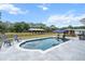 Outdoor pool with a nearby barn, poolside chairs, and covered bar area in a private setting at 6824 283Rd E St, Myakka City, FL 34251