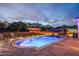Evening shot of outdoor pool with lighting highlighting the adjacent barn and bar area at 6824 283Rd E St, Myakka City, FL 34251