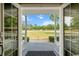 Scenic view from the front porch overlooking the expansive front lawn and lush landscape at 6824 283Rd E St, Myakka City, FL 34251