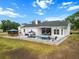 Aerial view of a white home's rear exterior featuring a pool, gazebo, and tastefully designed patio area at 6824 283Rd E St, Myakka City, FL 34251