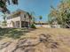 Spacious backyard featuring a home with a screened-in porch and two-car garage at 770 Yale St, Englewood, FL 34223