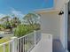 Balcony with white railing and a beautiful view of surrounding greenery at 770 Yale St, Englewood, FL 34223