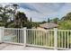 Balcony view with lush trees, blue sky, and partial home view at 770 Yale St, Englewood, FL 34223