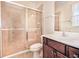 Tiled bathroom with walk-in shower, vanity and sink at 770 Yale St, Englewood, FL 34223