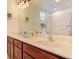 Bathroom featuring dual sinks, granite counters, and decorative fixtures at 770 Yale St, Englewood, FL 34223