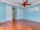 Bedroom with hardwood floors, ceiling fan, and ensuite bath at 770 Yale St, Englewood, FL 34223