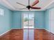 Spacious bedroom with hardwood floors, tray ceiling, and natural light at 770 Yale St, Englewood, FL 34223