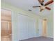 Bedroom with ceiling fan, closet, and attached bath with tiled shower at 770 Yale St, Englewood, FL 34223