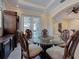 Bright dining area features a glass table, elegant chairs, and natural lighting at 770 Yale St, Englewood, FL 34223