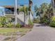Exterior view of a two-story house with a brick-paved driveway and screened-in porch at 770 Yale St, Englewood, FL 34223