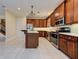 Spacious kitchen with custom cabinetry, stainless steel appliances, and a center island at 770 Yale St, Englewood, FL 34223