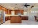 Spacious kitchen with wooden cabinets, stainless steel appliances, and a cozy island at 770 Yale St, Englewood, FL 34223