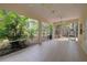 Spacious tiled patio with large opening looking out to lush greenery at 770 Yale St, Englewood, FL 34223
