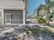 View of a screened-in porch and backyard featuring tropical landscaping at 770 Yale St, Englewood, FL 34223