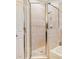 Bathroom shower with tan tiled walls and glass door at 770 Yale St, Englewood, FL 34223