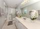 Well-lit bathroom with a glass-enclosed shower, white vanity, and neutral decor at 791 Cumberland Rd, Venice, FL 34293