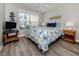Inviting bedroom with a beachy vibe, wood floors, and natural light from the window at 791 Cumberland Rd, Venice, FL 34293