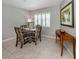 Cozy dining area features tile flooring, shuttered window, and decorative console table at 791 Cumberland Rd, Venice, FL 34293