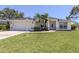Inviting one story home featuring mature landscaping, an attached two car garage and a manicured lawn at 791 Cumberland Rd, Venice, FL 34293