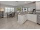 Bright eat-in kitchen with tile floors, shutters, sink and view of the dining area at 791 Cumberland Rd, Venice, FL 34293