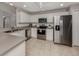 Spacious eat-in kitchen boasts stainless steel appliances and ample white cabinetry at 791 Cumberland Rd, Venice, FL 34293