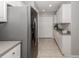 Bright kitchen featuring stainless steel refrigerator and ample white cabinetry for storage at 791 Cumberland Rd, Venice, FL 34293