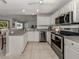 Bright kitchen with stainless appliances, tiled floors, and neutral countertops at 791 Cumberland Rd, Venice, FL 34293