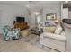 Living room with neutral tile flooring and stylish furniture, featuring a large rug at 791 Cumberland Rd, Venice, FL 34293