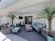 Relaxing covered patio featuring wicker furniture, ceiling fan, and seamless access to the indoors at 791 Cumberland Rd, Venice, FL 34293