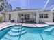Inviting pool area with patio, comfortable seating, and lush tropical landscaping at 791 Cumberland Rd, Venice, FL 34293