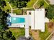 Overhead view of a community pool, clubhouse, manicured grounds, and walking paths at 810 Anchorage Ln, Palm Harbor, FL 34685