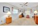 Bedroom features neutral carpet, ceiling fan and rocking chair at 810 Anchorage Ln, Palm Harbor, FL 34685