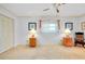 Bedroom with neutral carpeting, ceiling fan and closet with white doors at 810 Anchorage Ln, Palm Harbor, FL 34685