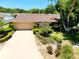 Inviting home with a well-manicured front yard, driveway, and a two-car garage, showcasing curb appeal at 810 Anchorage Ln, Palm Harbor, FL 34685