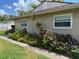 Charming home exterior featuring a well-maintained garden and a glimpse of the lovely surroundings at 810 Anchorage Ln, Palm Harbor, FL 34685
