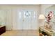 Bright Foyer with tile flooring, decorative glass front door, and lovely console table at 810 Anchorage Ln, Palm Harbor, FL 34685