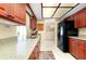 Kitchen features tile floors, updated appliances and wood cabinets at 810 Anchorage Ln, Palm Harbor, FL 34685