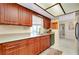 Updated kitchen with wood cabinets, stone countertops, stainless steel appliances and natural light at 810 Anchorage Ln, Palm Harbor, FL 34685