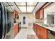 Efficient kitchen with matching cabinetry, black appliances, a stainless sink, and bright recessed lighting at 810 Anchorage Ln, Palm Harbor, FL 34685