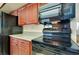 Well-equipped kitchen features cherry wood cabinets, granite countertops, and sleek black appliances at 810 Anchorage Ln, Palm Harbor, FL 34685