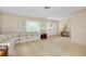 Inviting living room with large windows, cozy seating, and carpeted floors at 810 Anchorage Ln, Palm Harbor, FL 34685