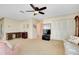 Open-concept living room with a ceiling fan and doors to an outdoor area at 810 Anchorage Ln, Palm Harbor, FL 34685