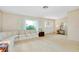 Large living room featuring plush carpeting, decorative sofa, and inviting entryway at 810 Anchorage Ln, Palm Harbor, FL 34685