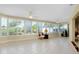 Bright sunroom with tiled floor, multiple windows, and ceiling fans at 810 Anchorage Ln, Palm Harbor, FL 34685