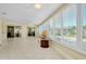Bright sunroom with tiled floors, many windows and multiple ceiling fans at 810 Anchorage Ln, Palm Harbor, FL 34685