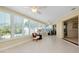 Bright sunroom with tiled floor, multiple windows, and a ceiling fan at 810 Anchorage Ln, Palm Harbor, FL 34685