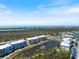 A sprawling aerial perspective of the community, displaying its vibrant mix of residences, recreational amenities, and serene water features at 8403 Placida Rd # 304, Placida, FL 33946